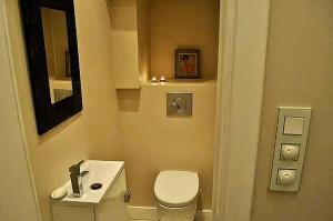 a small bathroom with a toilet and a sink at Rossetti in Nice