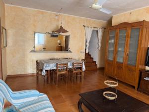 a living room with a table and chairs and a mirror at Villa Francesca in Flumini di Quartu +9 photos