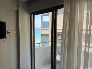 a bathroom with a window with a view of the ocean at Sergent Hotel in Kuşadası