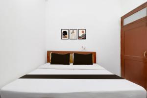 Ένα ή περισσότερα κρεβάτια σε δωμάτιο στο Hotel O Welcome Guest House