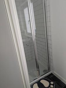a shower in a bathroom with a glass shower stall at Corby Town Vacations Rooms available for Couples & Singles in Rockingham