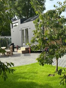 a tiny house sitting on top of a yard at my-tinyhouse in Neuendorf-Sachsenbande