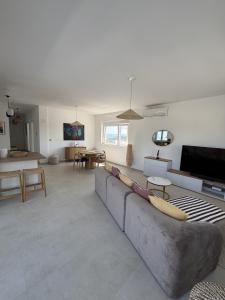 a living room with a couch and a table at Alma Mare - Modern Apartment with Soul & View in Murter