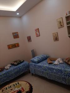 two twin beds in a room at Dimora Stabiae in Castellammare di Stabia