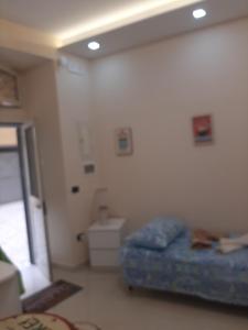 a room with a bed in the corner of a room at Dimora Stabiae in Castellammare di Stabia +10 photos