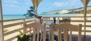a balcony with a table and chairs on the beach at Casa Aranci in Cattolica Eraclea
