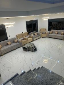 a large living room with couches and a table at مزرعة وفيلا غابة الارز in Jerash
