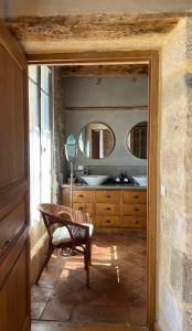 a bathroom with a sink and two mirrors at Le patio de Collias in Collias