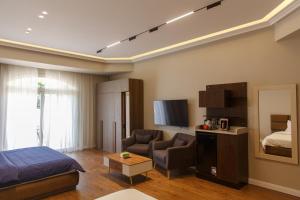 a bedroom with a bed and a couch and a tv at Munir`s residence 3 in Cairo