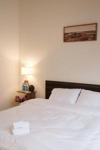 a white bed with two folded towels on it at Last island in Ho Chi Minh City