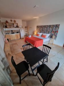 a bedroom with a bed and a table and chairs at Pousada Village Gostoso in São Miguel do Gostoso