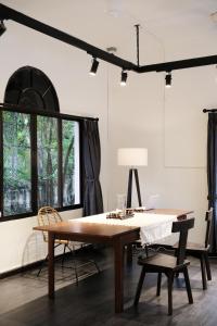 a table and chairs in a room with a window at Last island in Ho Chi Minh City