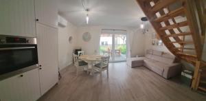 a living room with a table and a couch at Zakątek Rumiankowa Rewal in Rewal +2 photos