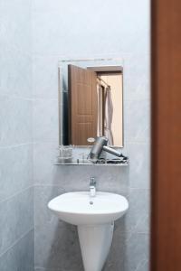 a bathroom with a sink and a mirror at Last island in Ho Chi Minh City