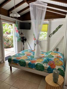 a bedroom with a bed with a dress on it at Le ptit paradis créole in Sainte-Rose +84 photos