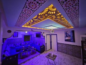 a living room with purple lighting and a couch at Bluemoon house in Chefchaouen