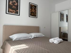 a bedroom with a bed with two towels on it at A&A Appartment 2 in Timişoara