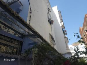 a building with blue and white walls and balconies at Bluemoon house in Chefchaouen