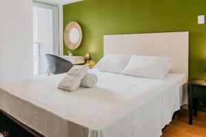 a large white bed with two pillows on it at Engaging 2BR rooftop view in Barranco in Lima