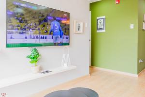 a living room with a large tv on a wall at Engaging 2BR rooftop view in Barranco in Lima