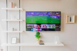 a flat screen tv hanging on a wall at Engaging 2BR rooftop view in Barranco in Lima
