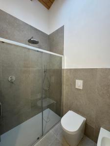 a bathroom with a toilet and a glass shower at FilMa Seagarden Villa in Pula +36 photos