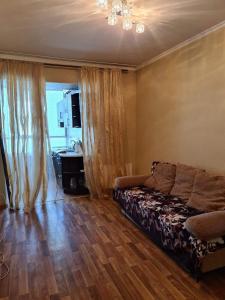 a bedroom with a bed and a bathroom with a sink at Rohovska appartment in Odesa