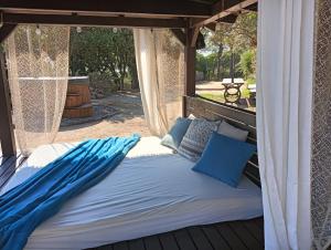 a bed in a gazebo with blue pillows at La Casita - Boutique Retreat Barcelona Coast Sea View in Sant Andreu de Llavaneres +55 photos