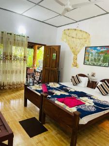 a bedroom with a large bed in a room at Sigiri Niwahana Home Stay in Sigiriya
