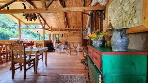 a dining room with a table and vases on a cabinet at Daravand Restaurant & Guest House in Dilijan