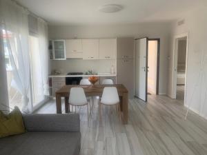 a kitchen and dining room with a table and chairs at SirmioGarda House in Sirmione