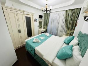 a bedroom with a large bed with blue pillows at LA MAİSON FAMILY Hotel in Istanbul