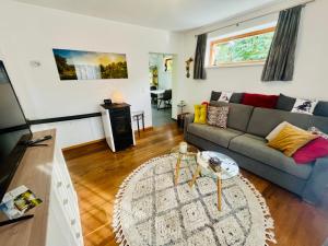 a living room with a couch and a table at Ferienhaus Sausalblick in Großklein +128 photos