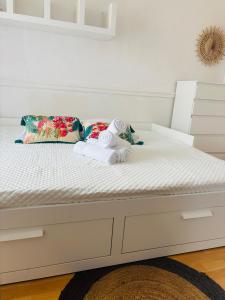 Una cama blanca con un animal de peluche. en Smart stay entre la defense et paris, en Argenteuil