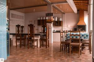 a kitchen with a table and chairs in a room at Pousada Fatimar in Salinópolis