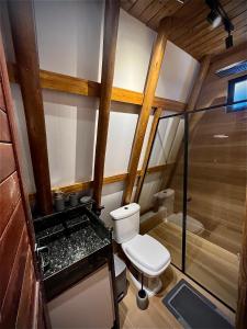 a small bathroom with a toilet and a shower at Pousada Quilombo do Tibau in Tibau +48 photos