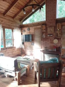a room with a bed and a table in a cabin at Cabaña Kultrum Mar Azul in Mar Azul