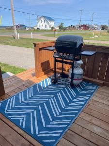 a grill sitting on a rug on a deck at Chez Thomas, la maison du pêcheur in Grande Anse