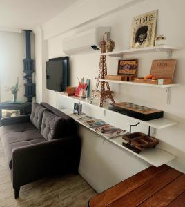 a living room with a couch and a counter with shelves at Seaside villa Sunrise Sea view, fully Private Pool in Akyarlar