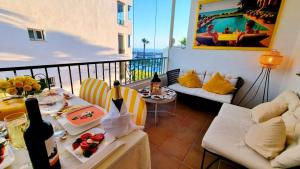 a balcony with a table with wine bottles on it at DiCaprio - Sunset Ritual incl I by MovieStar Holidays in Mijas Costa