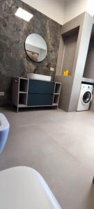 a bathroom with a sink and a washing machine at Villeriunite - Villa Dalia in Baia Verde +28 photos