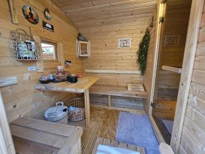 a wooden cabin with a table and bench in it at Willa Arletta pokoje i strefa SPA in Jastrzębia Góra