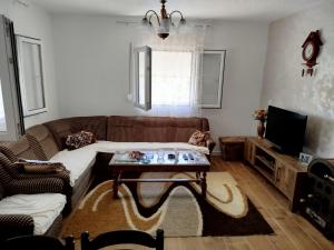 a living room with a couch and a coffee table at Kuća Duskic in Kunje
