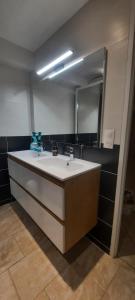 a bathroom with a sink and a mirror at Chambre CHARDON - Maison partagée - 2 personnes in Saint-Sauvant +9 photos