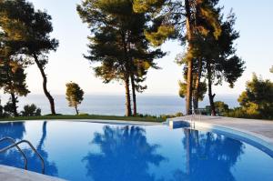 a swimming pool with a view of the ocean at Villa with Sea Views in a Gated Complex in Kriopigi