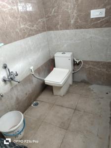 a bathroom with a toilet and a sink at Lotus home stay 2BHK in Mysore