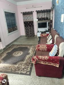 a living room with a couch and a rug at Lotus home stay 2BHK in Mysore