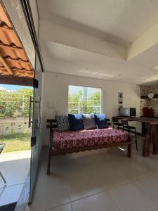 a living room with a bench with pillows on it at Casa de Pedras in Prado