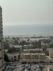 un aparcamiento con coches aparcados y una playa en 5 Star Comfort - Luxury Sea View, en Ajman