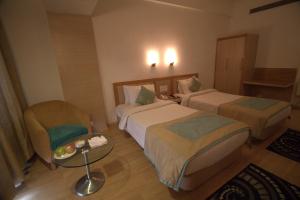 Letto o letti in una camera di IRA By Orchid Bhubaneswar